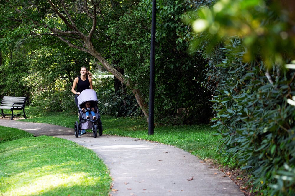 Mom with jogging stroller in park